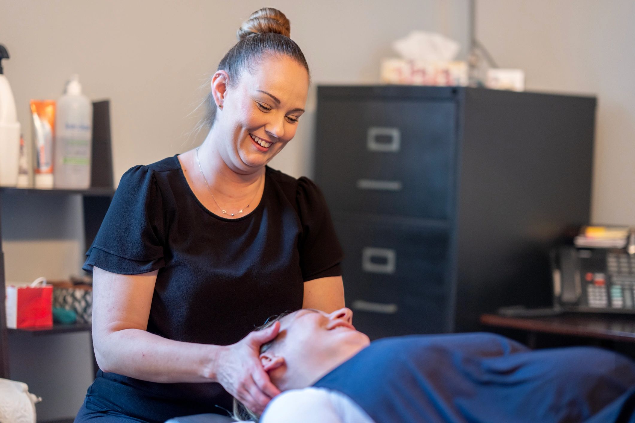 Professional therapist providing a gentle neck massage